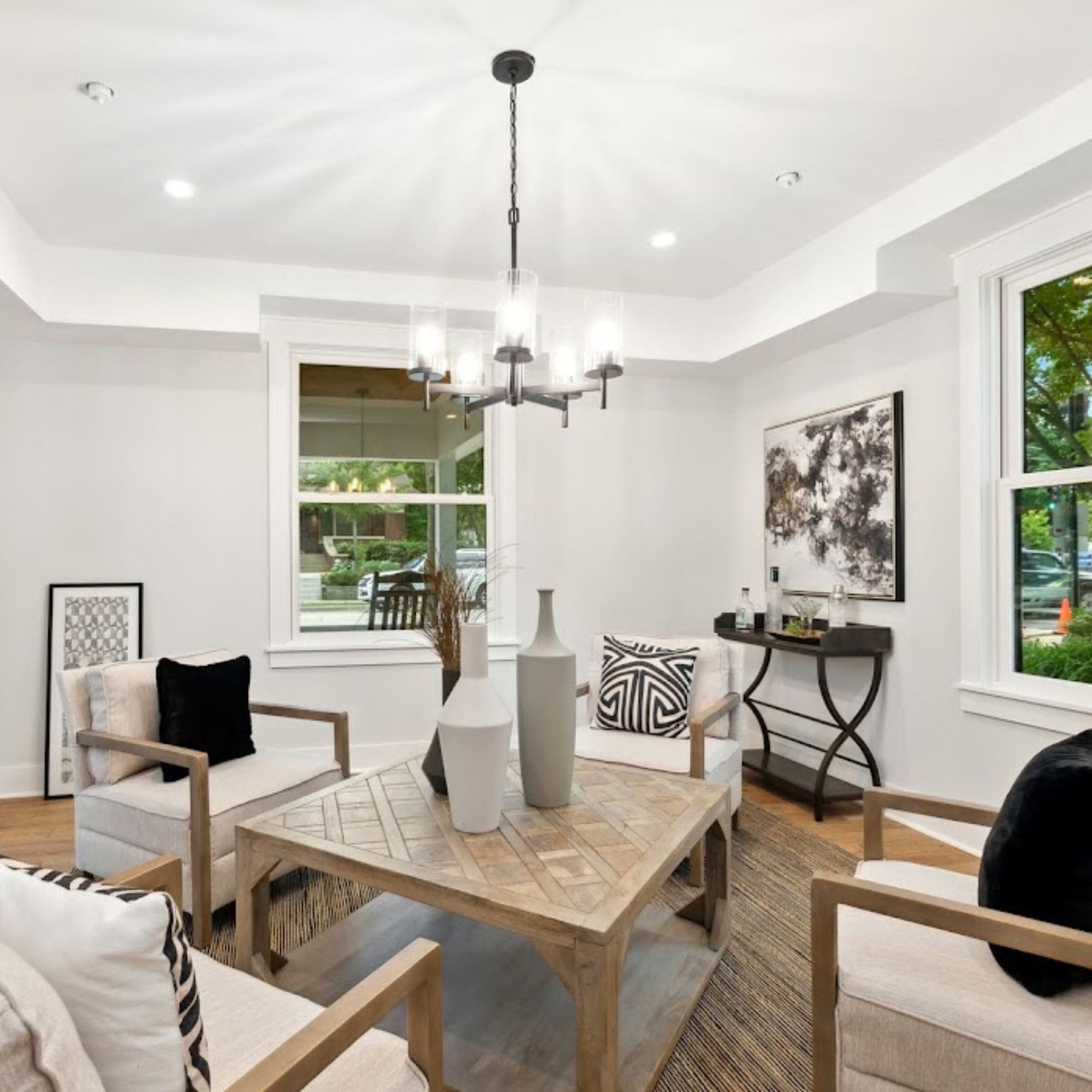A home staged modern living room with pristine white walls and beautiful hardwood flooring.