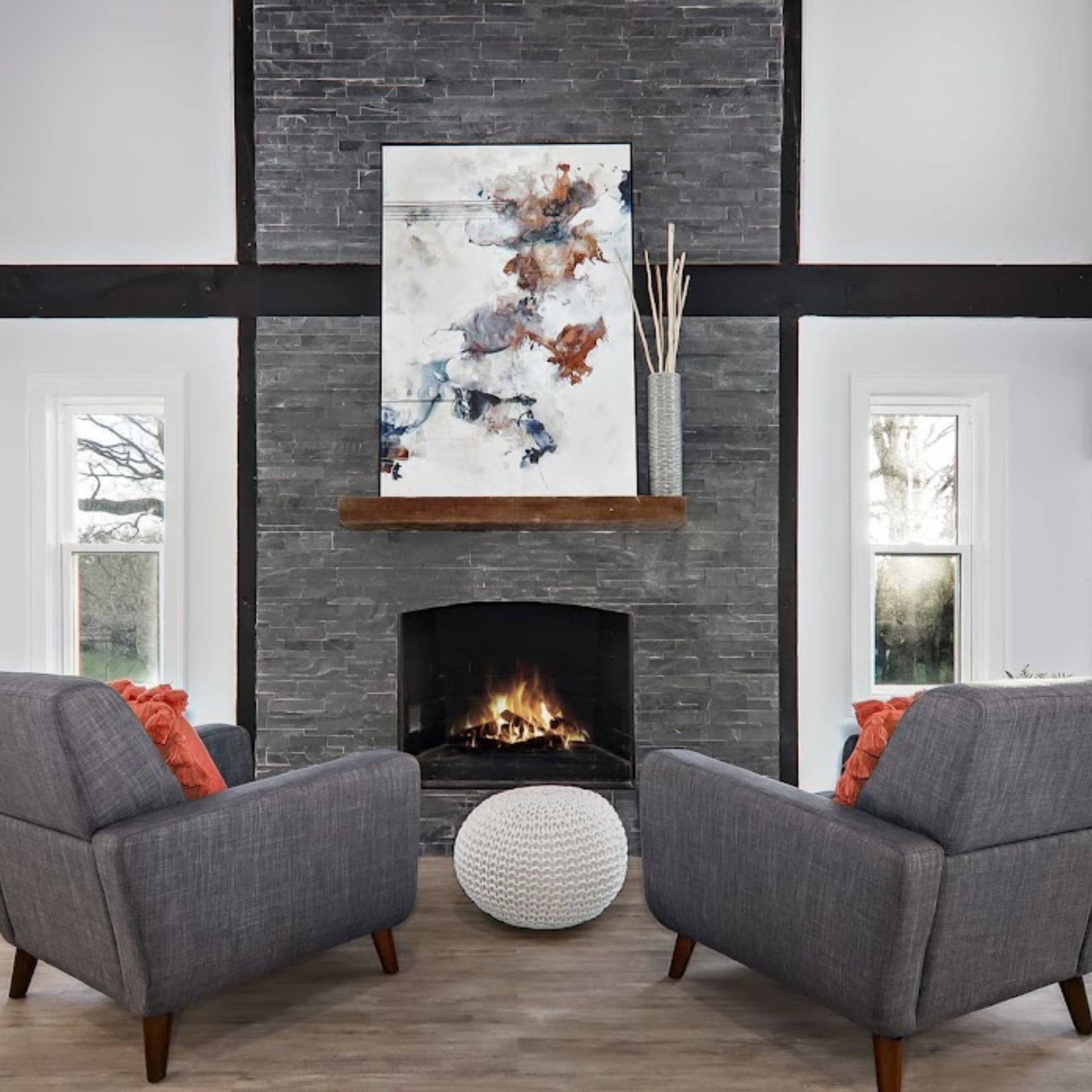 Cozy home staged living room featuring two chairs and a warm fireplace, creating a perfect spot for relaxation.