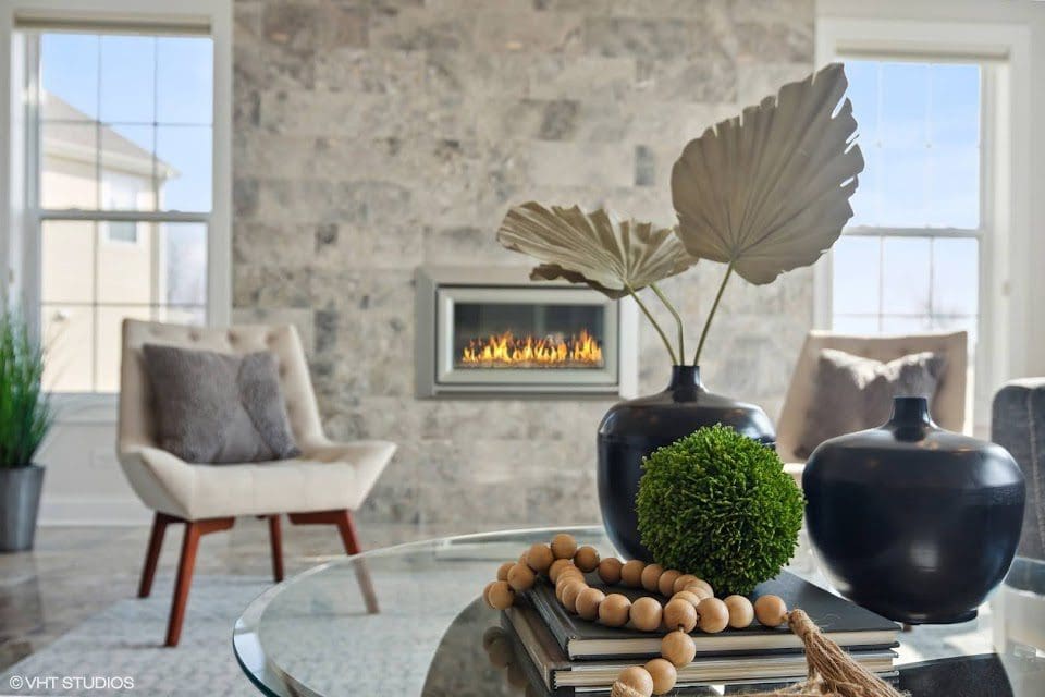 Inviting living room with a fireplace and an elegantly decorated mantle.