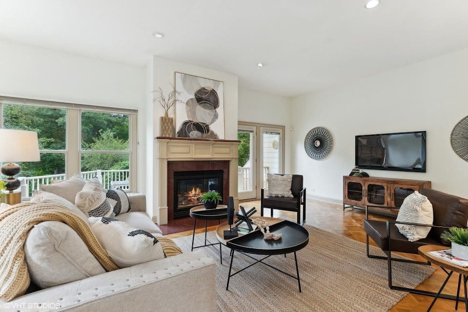 A comfortable staged living room adorned with a fireplace and cozy seating arrangements.