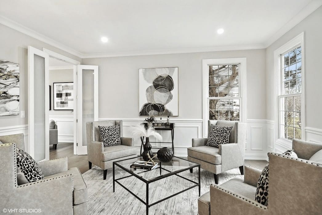 A staged living room showcasing an open floor plan and neutral colors.